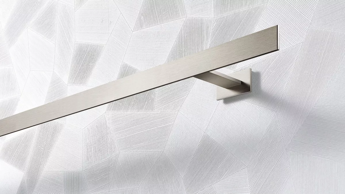 Interstil Gardinenstange Codex in der Farbe Edelstahl an einer gemusterten Wand vor einem Fenster montiert